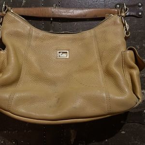 Dooney and Bourke yellow leather purse. Has small scratch /stain on front 
.